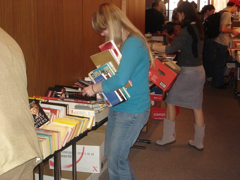 Tables covered with used books at a library book sale