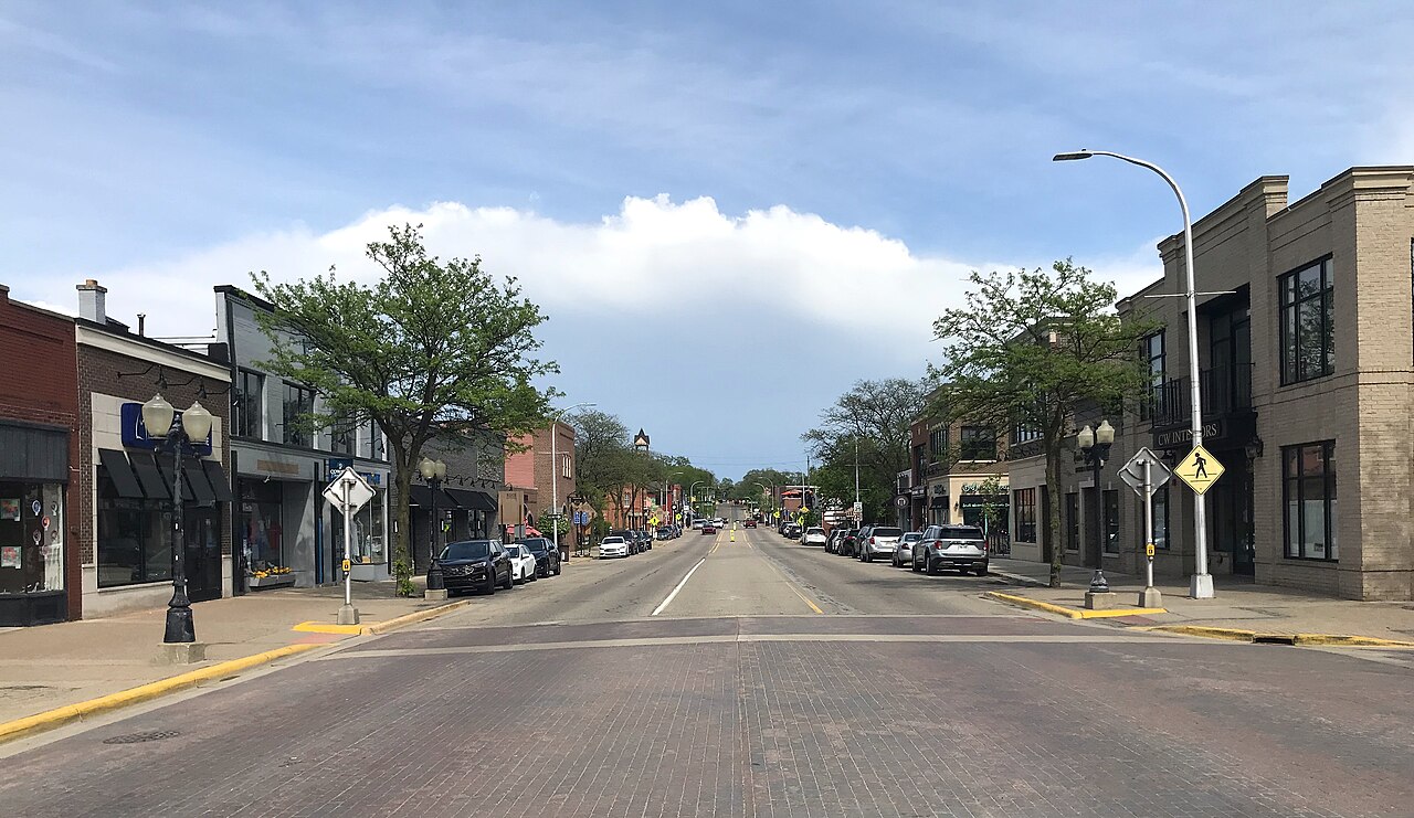 Buildings and traffic along a downtown Brighton street in May 2022