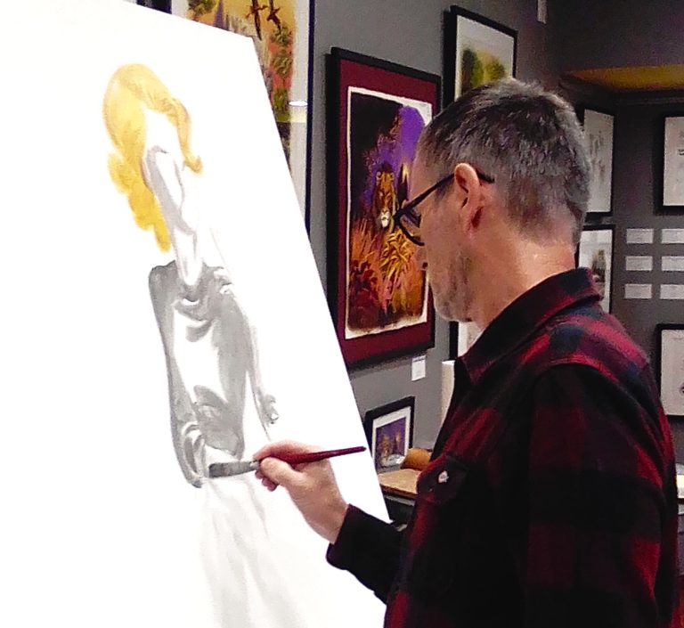 Artist painting a large canvas during a live performance