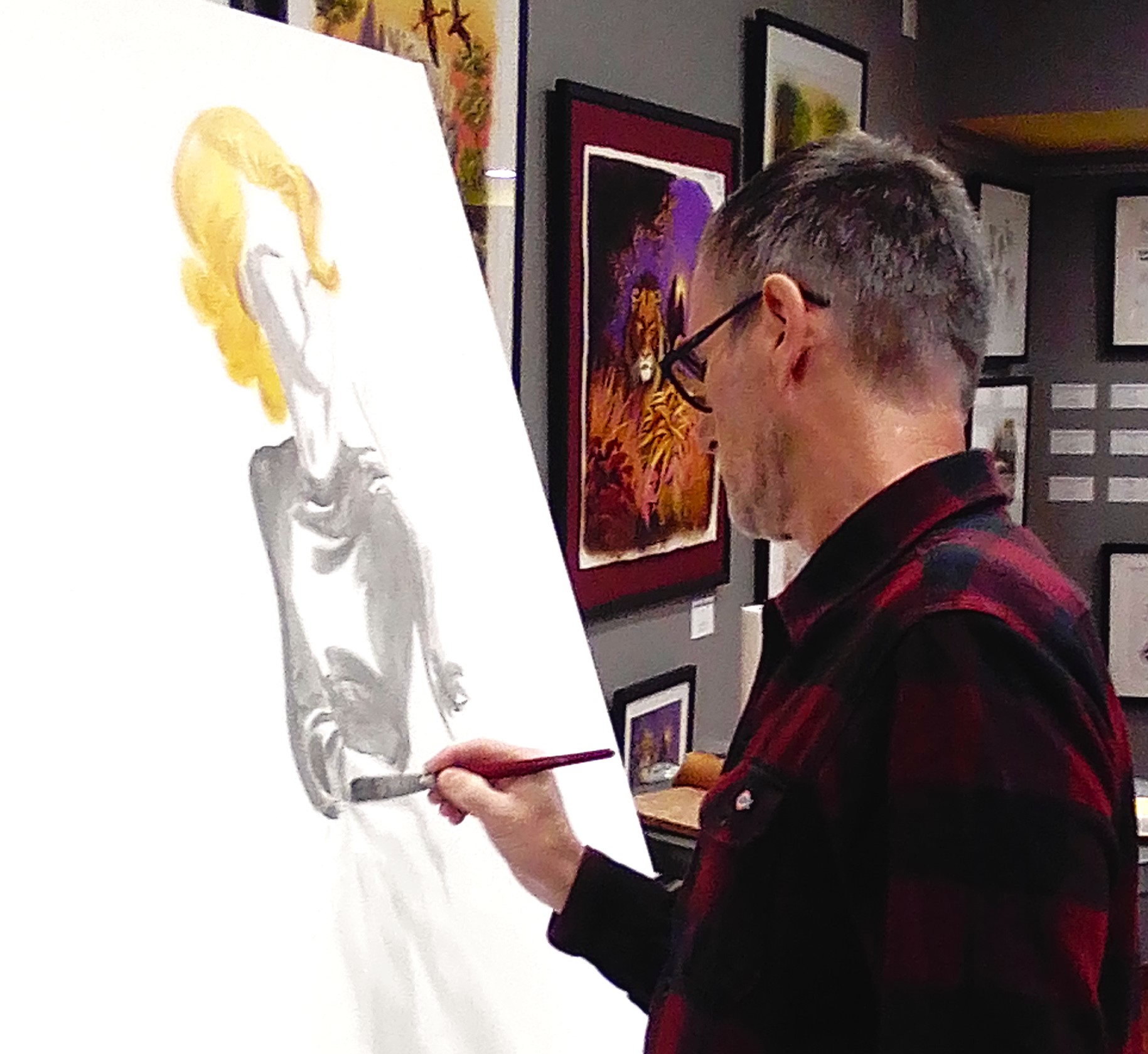Artist painting a large canvas during a live performance