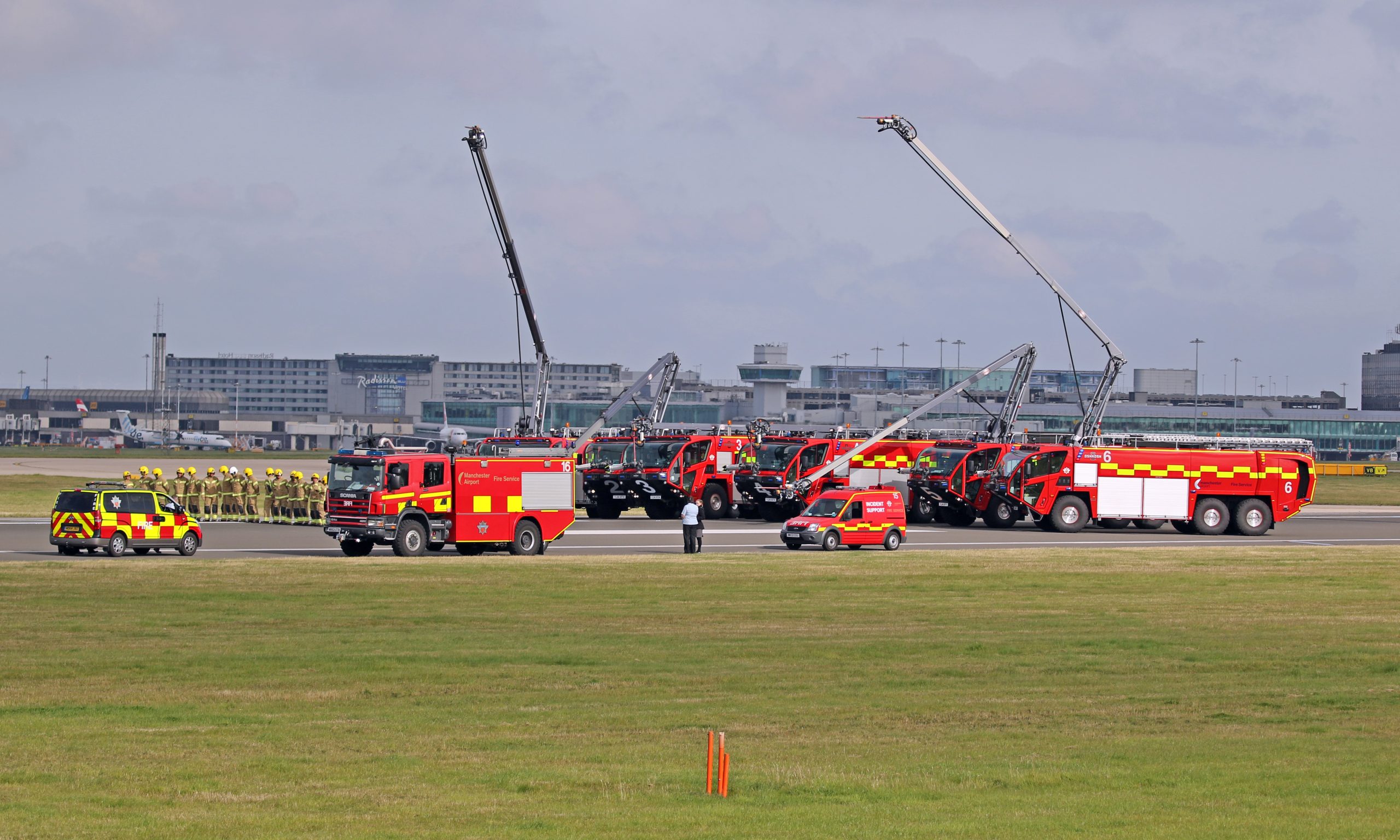 Line of red fire-rescue vehicles parked outdoors, used as an illustrative archive image