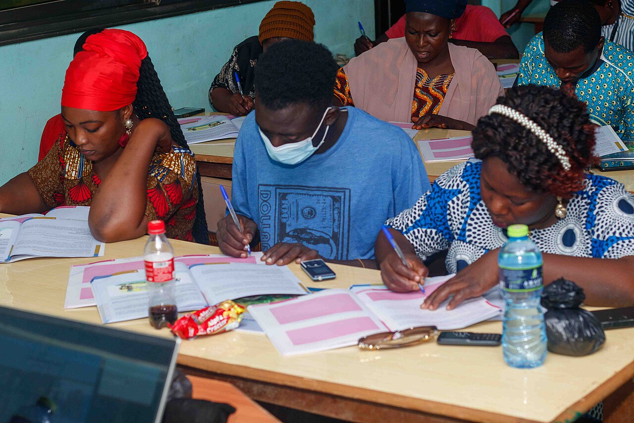 Adults seated in rows taking notes during an entrepreneurship seminar